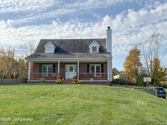 new england style home with a porch and a front lawn