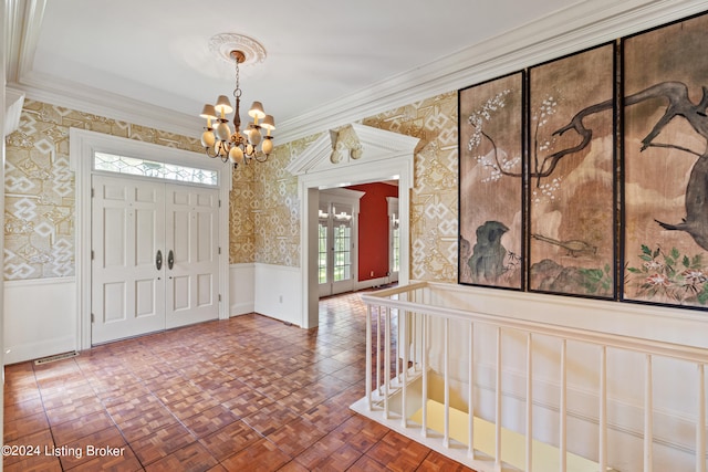 entryway featuring parquet floors, crown molding, and an inviting chandelier