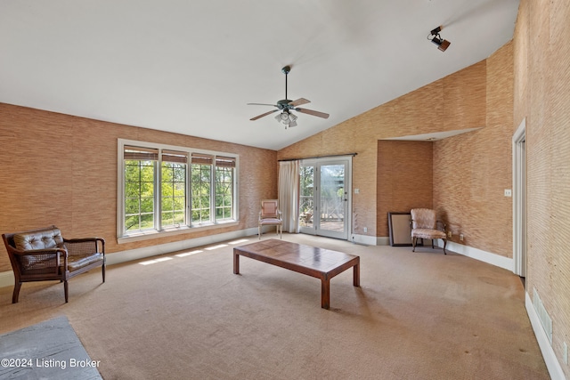 living room featuring a wealth of natural light, high vaulted ceiling, ceiling fan, and carpet