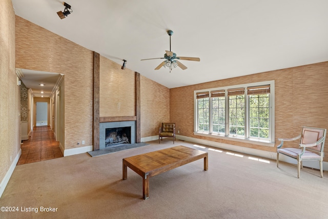 unfurnished living room featuring a fireplace, high vaulted ceiling, ceiling fan, and carpet flooring