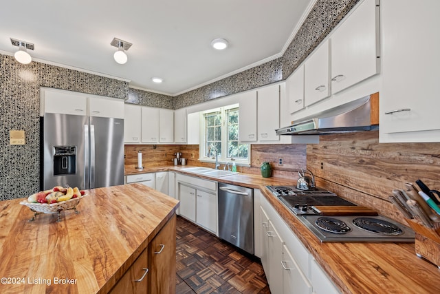 kitchen with dark parquet flooring, butcher block counters, sink, white cabinetry, and stainless steel appliances