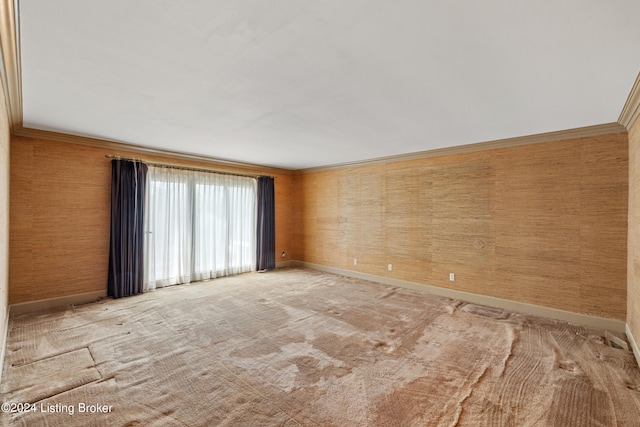 empty room with crown molding and light carpet