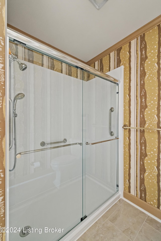 bathroom featuring tile patterned flooring and an enclosed shower