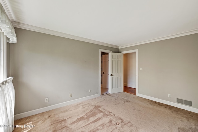 carpeted empty room featuring ornamental molding