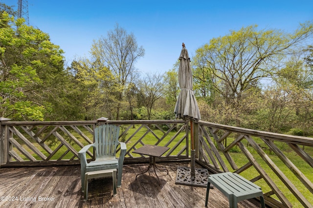 wooden terrace featuring a yard