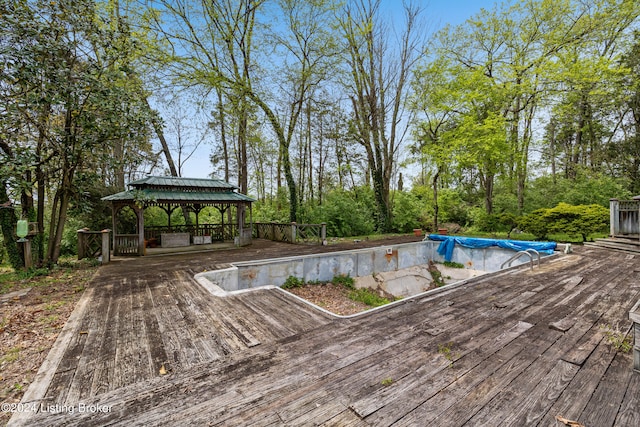 wooden deck with a gazebo and a covered pool