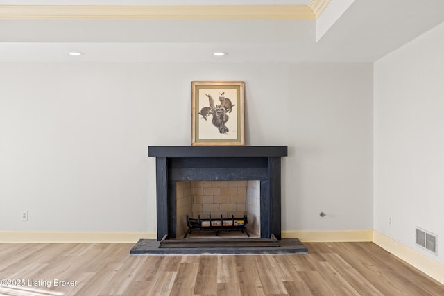 interior details with hardwood / wood-style flooring and ornamental molding