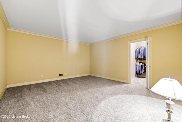 empty room with crown molding and carpet floors