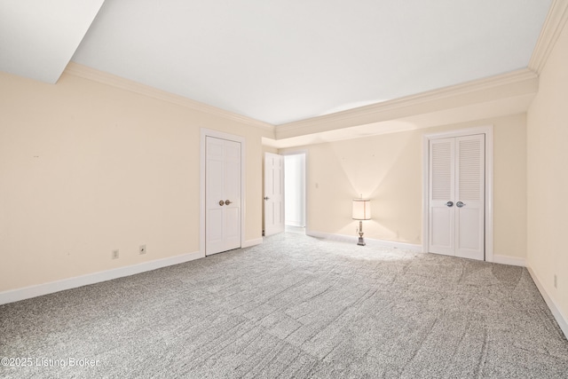 unfurnished room featuring ornamental molding and carpet