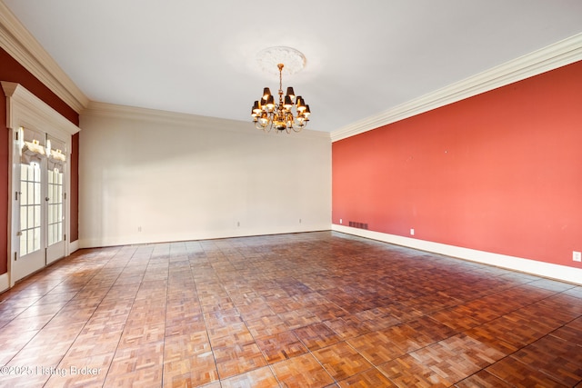 empty room featuring parquet floors, ornamental molding, and a chandelier