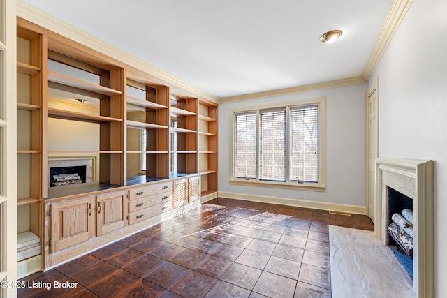 unfurnished living room with ornamental molding and a fireplace