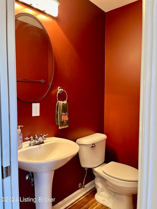 bathroom with toilet and hardwood / wood-style flooring