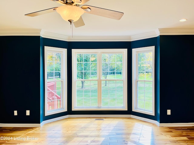 unfurnished room featuring light hardwood / wood-style floors, ornamental molding, and ceiling fan