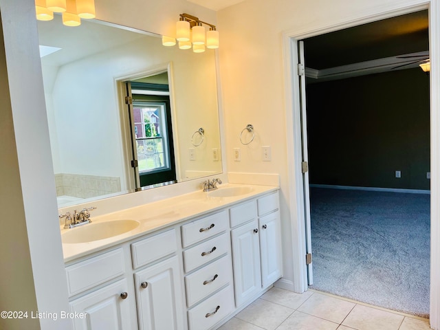 bathroom with vanity, a tub, and tile patterned floors