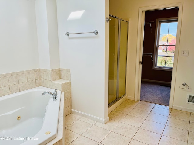 bathroom featuring tile patterned floors and separate shower and tub