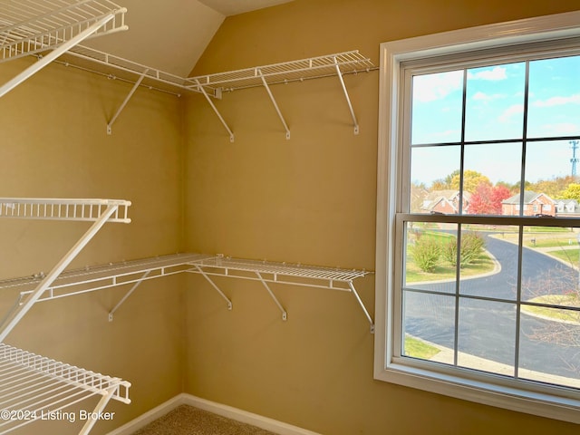 walk in closet featuring vaulted ceiling