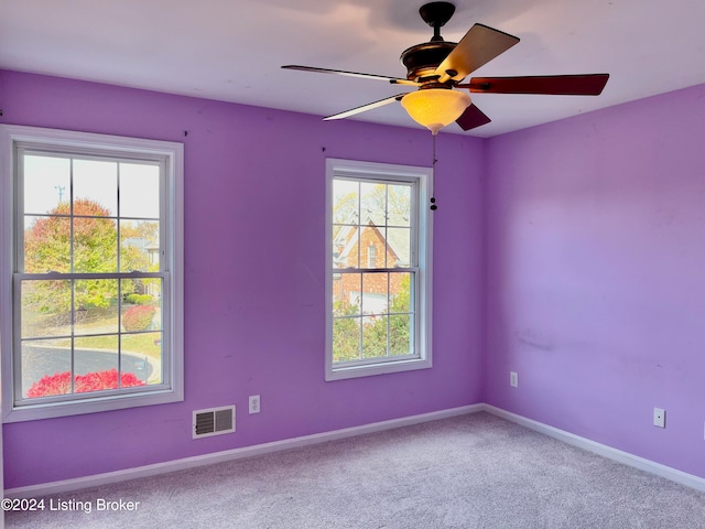 carpeted empty room featuring ceiling fan