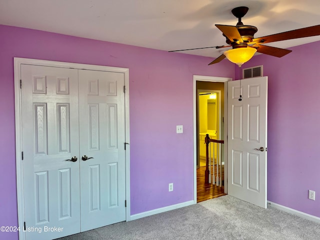 unfurnished bedroom with a closet, ceiling fan, and light colored carpet