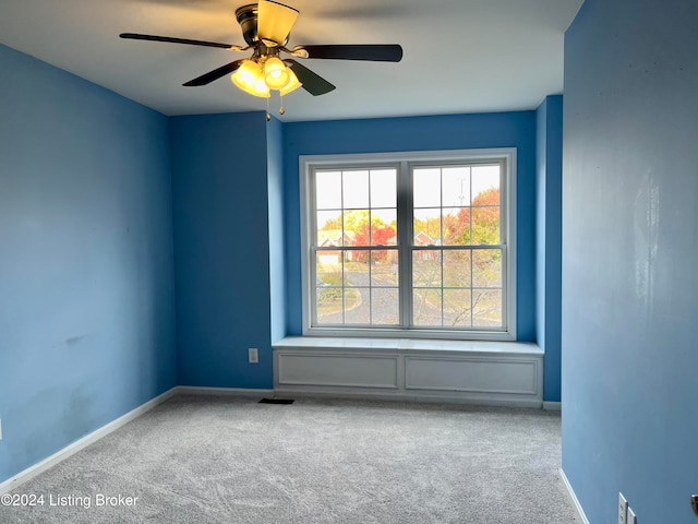 carpeted empty room with ceiling fan