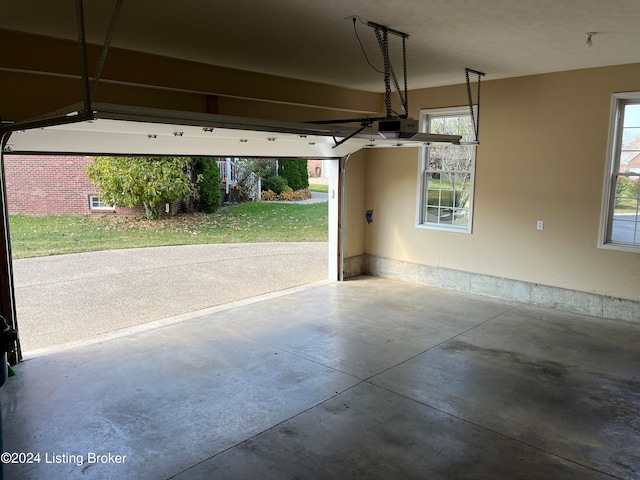 garage featuring a garage door opener and a lawn