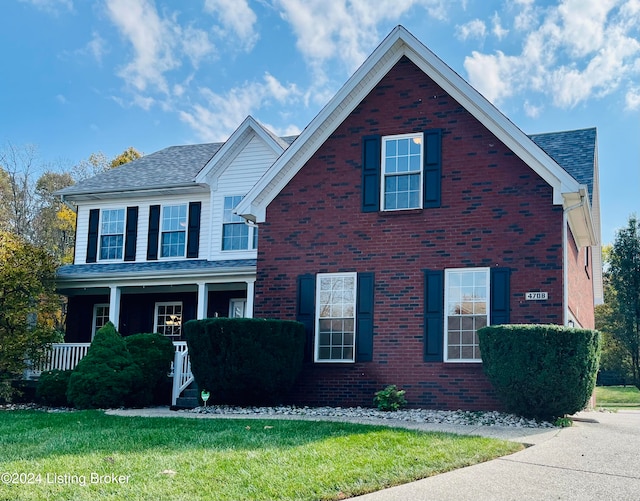 view of front property with a front yard and a porch