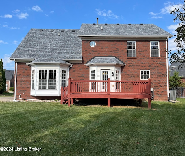 rear view of house with a wooden deck, a lawn, and central AC unit