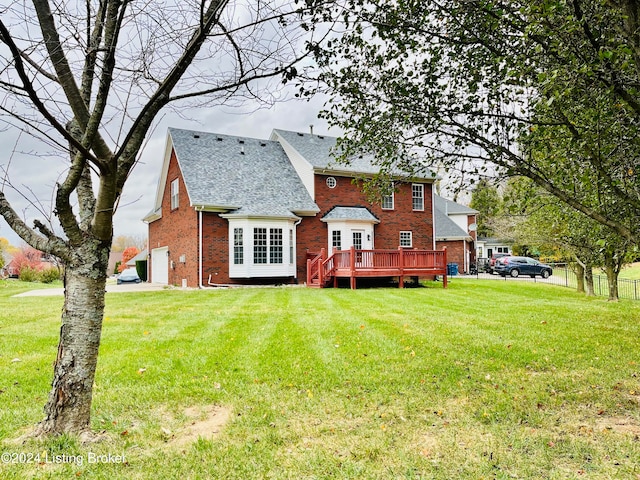 back of house with a deck and a lawn