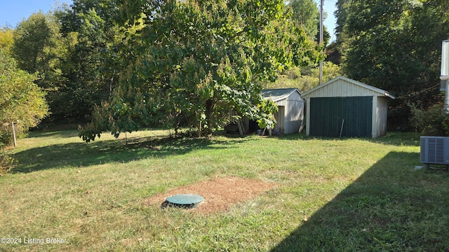 view of yard with a shed and central AC