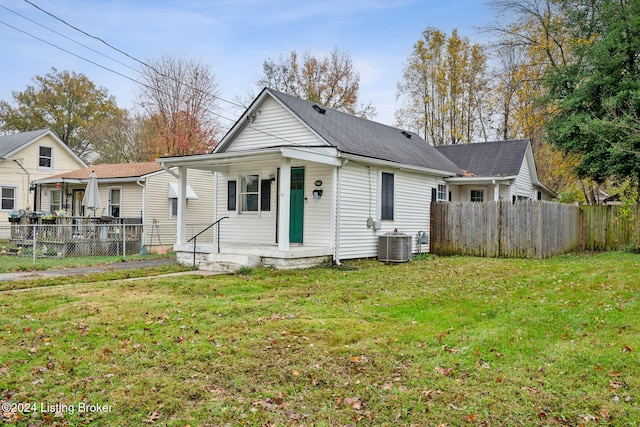 view of front of home with cooling unit and a front yard