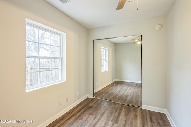 unfurnished room featuring dark hardwood / wood-style flooring and ceiling fan