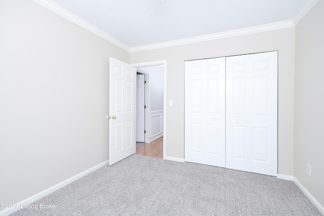 unfurnished bedroom featuring a closet, light carpet, and ornamental molding