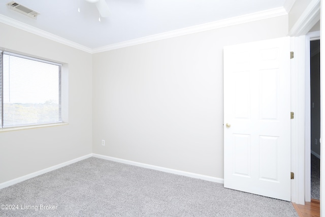 empty room with crown molding, carpet floors, and ceiling fan