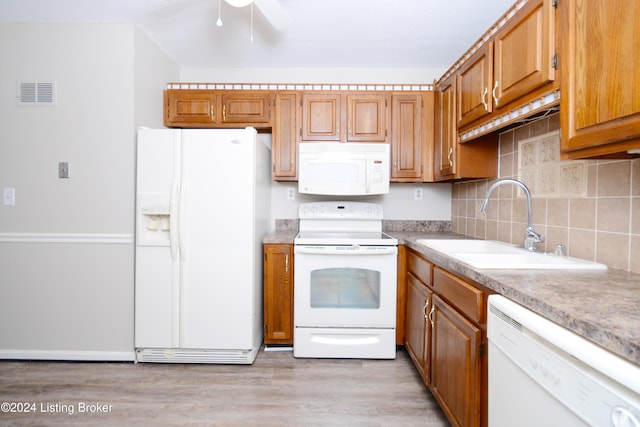 kitchen with ceiling fan, backsplash, light hardwood / wood-style floors, sink, and white appliances