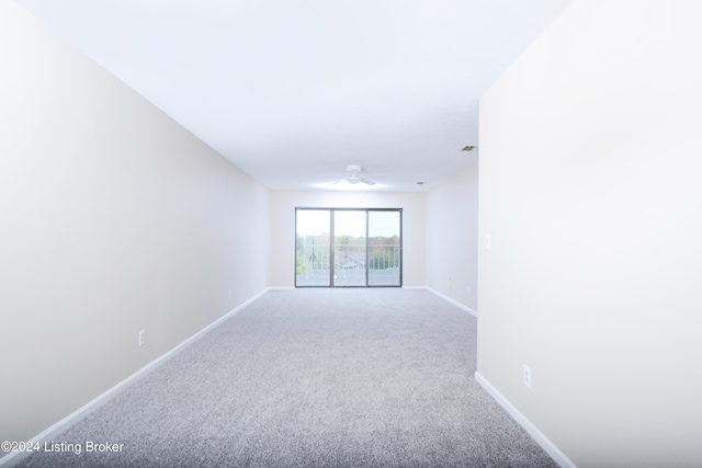 carpeted spare room with ceiling fan