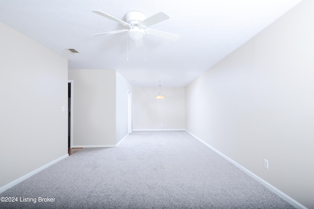 spare room featuring ceiling fan and carpet floors