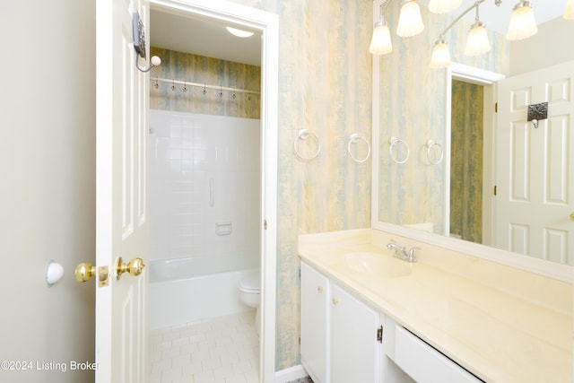 full bathroom featuring tiled shower / bath, vanity, toilet, and tile patterned floors