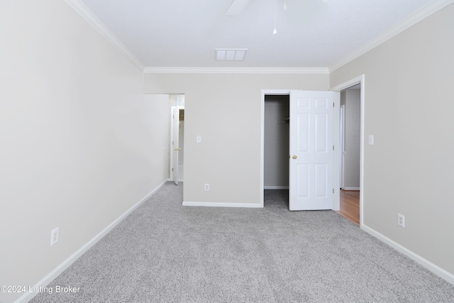 unfurnished bedroom with ornamental molding, carpet flooring, and ceiling fan