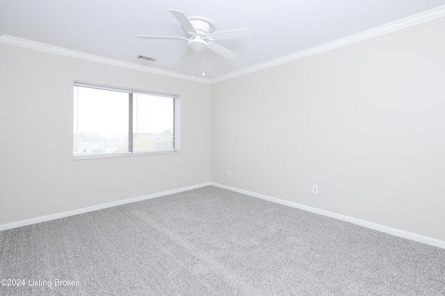 unfurnished room with crown molding, carpet, and ceiling fan