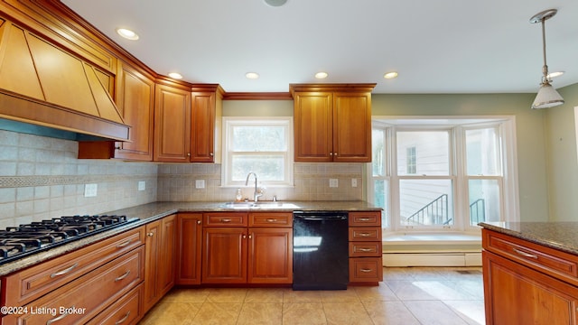 kitchen with tasteful backsplash, custom range hood, stone counters, black appliances, and a sink