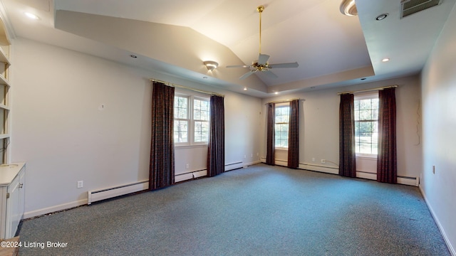 carpeted empty room with a ceiling fan, visible vents, baseboards, a tray ceiling, and vaulted ceiling