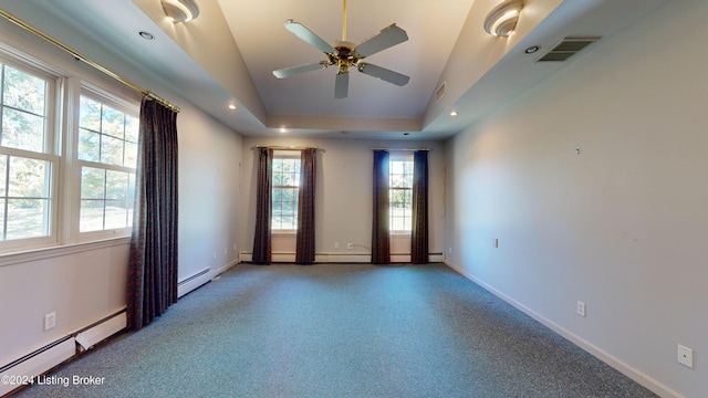 spare room featuring visible vents, baseboard heating, and baseboards