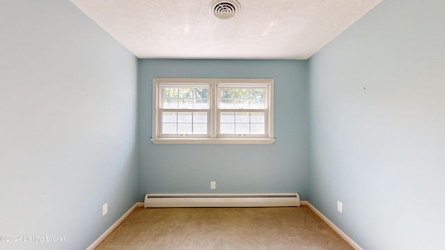 spare room with baseboards, a baseboard radiator, carpet floors, and visible vents