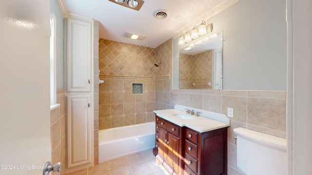 bathroom featuring tile patterned flooring, visible vents, tub / shower combination, toilet, and tile walls