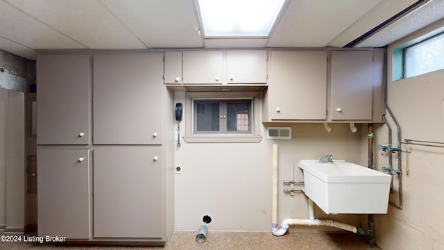 clothes washing area with laundry area, a sink, and washer hookup