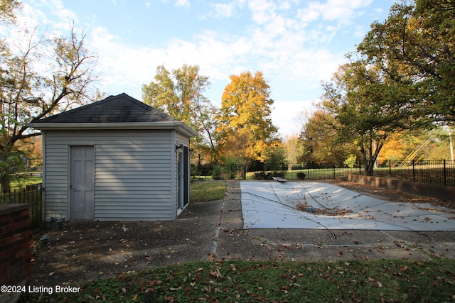 exterior space with an outdoor structure and fence private yard