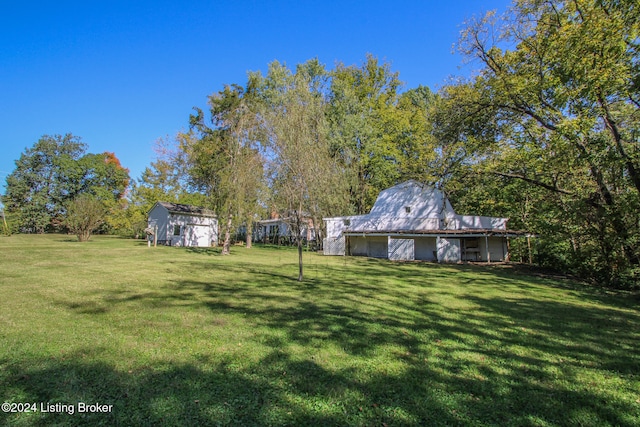 view of yard with an outbuilding and a barn