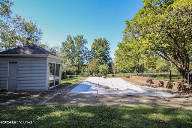 view of pool featuring an outbuilding and a fenced backyard