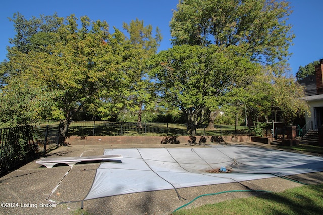 view of pool featuring a patio area and fence