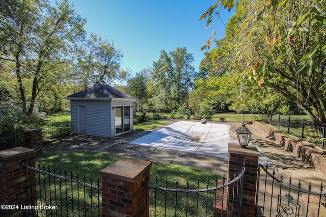 view of pool with a patio, a lawn, an outdoor structure, and fence