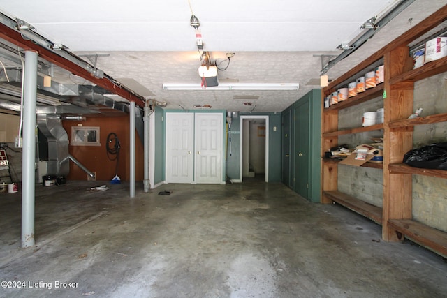 garage featuring heating unit and a garage door opener